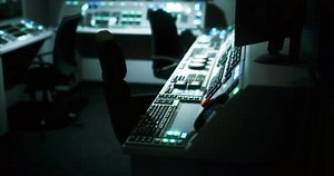 Control Room with Dim Lighting and Illuminated Equipment at Night