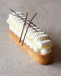 702K views · 6.8K reactions | Lemon praline tart, made with a sweet pasty case, hazelnut milk chocolate crunch, lemon cremeux and vanilla cream. I topped it with a white chocolate decoration and used a weave tip nozzle to pipe whipped ganache. Finished with a few little chocolate sticks! | Matt Adlard | Facebook