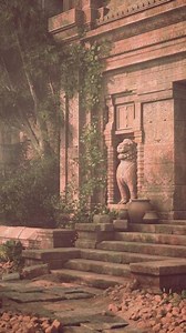 Ancient Stone Building With Statue on Steps