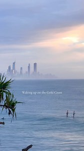 38K views · 697 reactions | Early morning vibes. ✨ Burleigh Heads  IG/gchandbook #GoldCoast #PlayGoldCoast #ThisIsQueensland #SeeAustralia #Beach #Wanderlust #Relax #Nature #Swim #Ocean #Nature #Sunrise [ID. Video shows a coastal scene with multiple individuals paddleboarding on calm waters, with a distant city skyline shrouded in mist under a pastel sunrise.] | Experience Gold Coast | Facebook