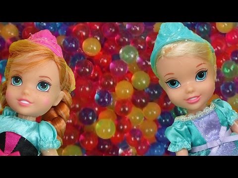 Elsa and Anna toddlers have fun in ORBEEZ ! They slide into colorful water beads!