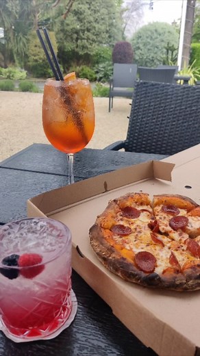 Slice up your night with our woodfired pizzas and sip on our signature cocktails, all served with a side of stunning outdoor ambience of the castle gardens at The Terrace 🍕🍹🌅 #PizzaNight #CocktailTime #TerraceBar #FitzpatrickCastleHotel #DublinEats | Fitzpatrick Castle Hotel