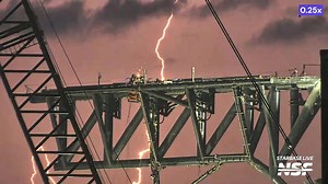 Lightning behind the Starbase Pad A Chopsticks as workers continue upgrades ahead of a potential booster catch on flight 5. | NASASpaceflight.com