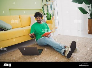 Full size photo of nice young man hold notepad video call laptop weekend green interior apartment indoors Stock Photo - Alamy