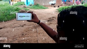 DISTRICT KATNI, INDIA - SEPTEMBER 18, 2019: Amazon Video logo displayed on smart phone screen by indian village man hand holding mobile concept Stock Photo - Alamy