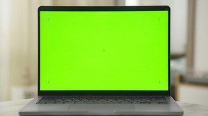 Dolly zoom shot of laptop with green screen