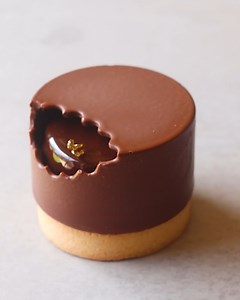 Looks like someone took a bite 👀 This has a vanilla and chocolate sable breton base, topped with a chocolate and caramel mousse. I finished it with a chocolate mirror glaze, then use a cookie cutter to create a 'bite' mark for the chocolate decoration! | Matt Adlard