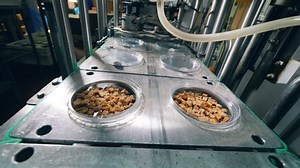 clip-1036232342-factory-machine-covering-bread-crumbs-foil-packing