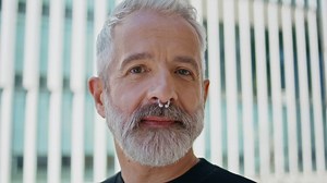 Grey hair man posing at urban building closeup. Brutal senior wearing nose ring | Premium Stock Video Footage