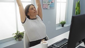 Woman Stretching at a Desk in an Office with Plants, Keyboard, Computer, and a Coffee Cup, Appearing Relaxed and Focused in a Stock Video - Video of productivity, relaxed: 346202961