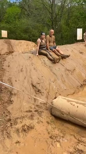 Tola Clemons and Dan McDonald having a great time at the muddy Dunk Wall obstacle. 2023 Charlotte Spartan Weekend Event! #spartan #spartanrace | Tom Maming