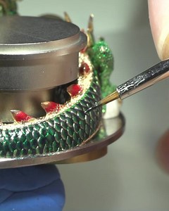 Creating the colorful, slithering gold dragon for the Astronomia Solar Baguette Tiger & Dragon took about three months. It begins with a detailed drawing that then becomes a computer-aided (CAD) rendering because it must fit properly in the dial among the Astronomia vertical movement and the tiger. The gold cast is hand-painted with acrylic paint. Because of its immense size and complexity, the gold sculpture is separated into parts and the individual pieces are reconstructed inside the dial. Th