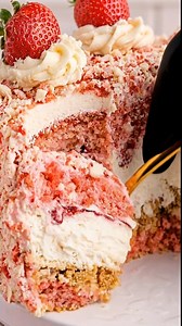 Strawberry Shortcake Cheesecake: The ultimate nostalgia trip on a plate! 🍓🍰 Inspired by the classic Good Humor ice cream bars, this towering dessert is a texturally perfect mashup. It features a rich, creamy cheesecake layer (sitting on a graham cracker crust) sandwiched between two layers of moist, pink strawberry cake made from a mix. The entire cake is frosted with cream cheese frosting and completely coated in a signature "strawberry crunch" crumble made from crushed vanilla wafers and str