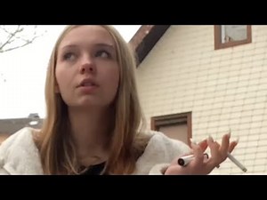 fetish girl smokes cigarette in skirt, gives interview and litters from balcony