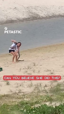 Girl carries large snake across creek in fearless wildlife moment