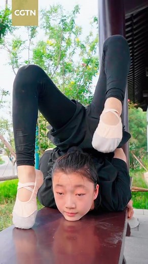CHINESE ACROBATICS Ai Yifan, 14, joined the Cangzhou Acrobatics Troupe four years ago, and regularly practices acrobatics with her peers. They train for three to four hours every day to hone their best and most graceful moves in the hope of one day shining on the big stage. Cangzhou City in Hebei Province is renowned as the birthplace of Chinese acrobatics. From here, Ai and her teammates receive the most advanced training and coaching available in China. #IntangibleHeritage #acrobatics | CGTN C