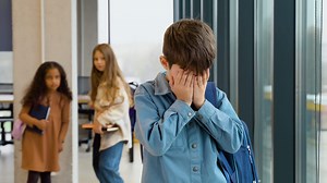 Couple pupils girls bullying and suppress the guy. Concept discrimination, racism and negative communication in school and society
