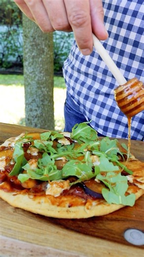 Enjoy a slice of paradise with our Peach & Goat Cheese Flatbread! Juicy peaches and creamy goat cheese on a crispy crust—perfect summer flavor! 🍑🧀✨ You’ll Need: 1 – Flatbread crust ½ C – Peach Buzz BBQ Sauce 2 oz – Prosciutto 2 oz – Goat Cheese 1 – Peach, sliced ½ oz – Arugula ¼ C - Honey 1 T – Bee Sting Hot Honey Rub Directions: 1. Preheat grill/smoker set up for indirect heat, to 350 degrees or prepare for open flame grilling. 2. Spread the Peach Buzz BBQ sauce on a flatbread crust leaving a