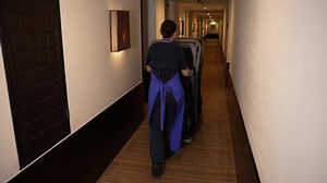 clip-1067029645-back-view-female-hotel-room-cleaner-walking