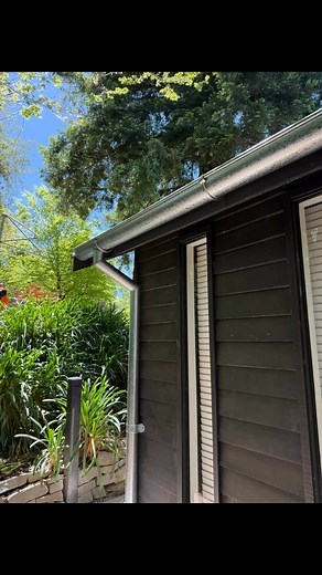 Gal half round gutter with a little standing seam above the rack door | Ashford Roofing