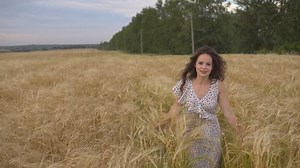 clip-30857650-young-pretty-woman-dress-running-field-smiling