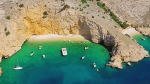 clip-3991377279-zlata-beach-anchored-boats-aerial-view-turquoise