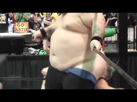 Wrestler Attempts to Smother Opponent