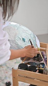 Welcome to the home of artist Tegan Lloyd, where a serene monochromatic palette comes alive through her vibrant, nature-inspired paintings. Texture takes centre stage, bringing interest and dimension to the space, complemented by black accents and the timeless beauty of oak parquetry floors. Camel grey marble and oak parquetry infuse warmth into the crisp white walls, while plush Oreo Boucle upholstery and Carrara marble add luxurious depth and tactile richness to the minimalist palette. Thought