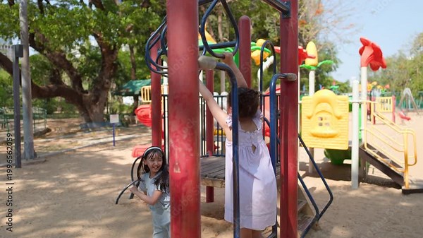 Young Thai Girl Playing on Monkey Bars at Lumpini Park Playground