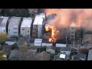 Firefighters battle raging flames at Albany Park building