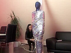 Lycra and shrink wrap mummification, and rope harness