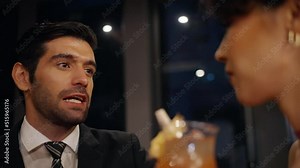 4K Caucasian man and woman flirting each other while hangout nightlife party at restaurant bar. Attractive female have romantic dating with boyfriend celebrating holiday event together at nightclub