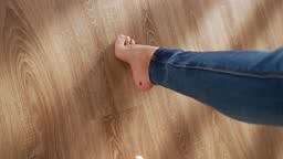 Beautiful Female Bare Feet Walk along the Parquet Floor of the House...