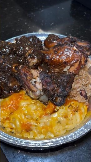 Oxtail + Jerk chicken over Mac & cheese and rice and peas