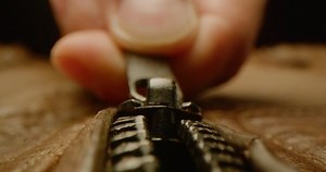 clip-1040216474-close-zipping-leather-jacket-macro-shot-zipper