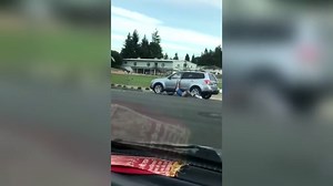 Man loses pants as he is dragged down street by car