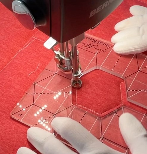 I would definitely not win a hand model contest but I’m happy with my #mqker hands all the same. They help me to sew and draw and quilt and do #rulerwork too! These are my #good measure #everyhexagon quilting templates for @brewersewing . Fabric is #cottonshot for @benartex_fabrics . Thread is @aurifilthread 50 wt. and the machine is a @berninausa #qseries. Hands are covered with gloves here so you can’t see the scar I have from my iron but believe me - it is there! #quiltong has brought me so m