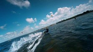 Kiteboarding on the lake. Woman kiteboarder flying a kite