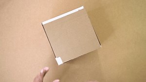 clip-3986612759-close-hands-taping-cardboard-box-using-adhesive