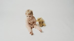 Little blonde baby and a plushie - Free Stock Video