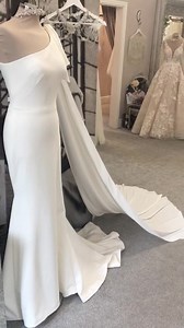 How incredibly stunning is ‘Maddox’ by our brand new designer Madi Lane 💕 an elegant one shoulder strap neckline with a dreamy bow detail cape 💕 #newgownalert #dreamdress #avarosehamilton# #madilane #SYTTDLancs #ourworld | Ava Rose Hamilton