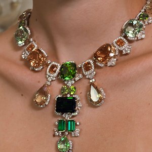 The yellow and white gold necklace and earrings feature “Lagoon” tourmalines and orange spessartine garnets. These Alta Gioielleria creations are paired with a yellow and white gold ring with green beryl and diamonds. #DGAltaGioielleria #DGFattoAMano #MadeInItaly #DolceGabbana | Dolce & Gabbana