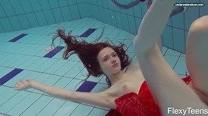 Red Dressed teen swimming with her eyes opened