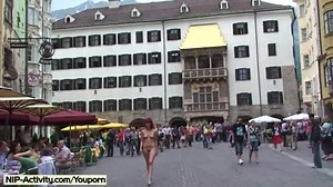 Naked redhead has fun in public streets