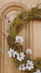 Sharing a simple Spring wreath DIY 🌿 I wanted to make a wreath out of mostly natural materials that will last through the summer, so I picked up an 18” grapevine wreath, reindeer moss, willow branches, a bundle of dried purple berry branches (not sure the name), dried Statice, and some faux daisies. I hot glued the moss onto the wreath and wove the flowers into the wreath, using hot glue to secure them. I love the wild, natural look of it on the garden house door. I usually struggle to find wre
