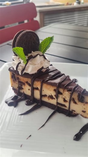 Mint Oreo Cheesecake - Creamy oreo cheesecake topped with coconut whipped cream, hot fudge & mint oreo. (Contains: Wheat, Soy & Nuts) | Great Sage