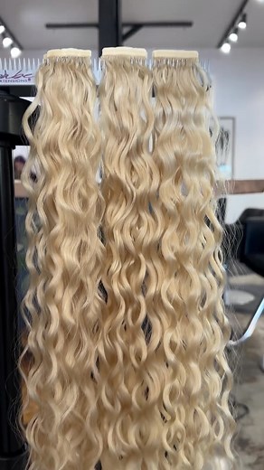 Out with the old multi-toned pink, and in with the new, longer, beautiful blue! 💙 @claudiadidmyhair @getting.buzzed installed 3 packs of Curly Tape-Ins in shades Sally to match her natural hair, then custom colored 3 packs in our shade Frankie with #pravana neon blue and aquamarine 🤩 Our curly extensions give you the flexibility to color or perm the hair. Be sure to keep in mind that it may alter the curl pattern. Although these extensions are applied and removed the same way that our regular 