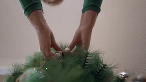 Decorating Artificial Christmas Tree with Ornaments