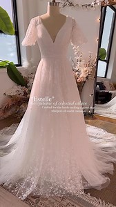 Meet Estelle – the epitome of celestial allure. Crafted for the bride seeking a gown that whispers of starlit romance, Estelle boasts a divine A-line silhouette, an alluring open keyhole back, and the celestial charm of pearl-infused tulle. This gown is a dance of light and air, embodying the magic of a celestial dream. • • #bridalgowns #weddingideas #weddinginspo #weddingplanning #weddingdressinspo #weddingdressinspiration #floralweddingdress #acotar #bridalstyle #bridaltrends #weddingtimeline 
