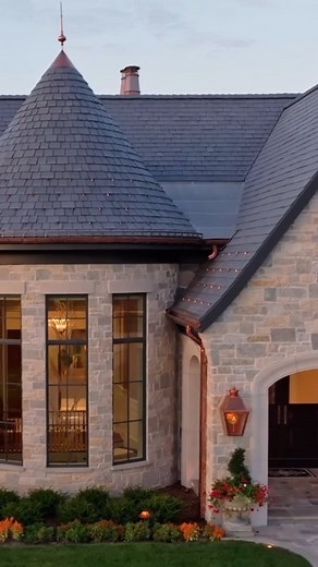 Where elegance meets edge. This dark composite slate roof and natural stone pairing by Hendel Homes is a true showstopper. Pictured: Multi-Width Slate | Smokey Gray #DaVinciRoofscapes #CompositeRoofing #LuxuryRoofing #SustainableStyle #HomeExteriorDesign #SlateRoof #ShakeRoof #RoofingInnovation #BuildingBetter | DaVinci Roofscapes